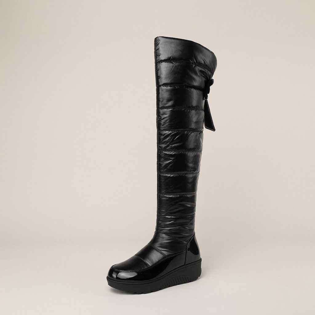 Adeline quilted tall boot, side view of the bow tassel