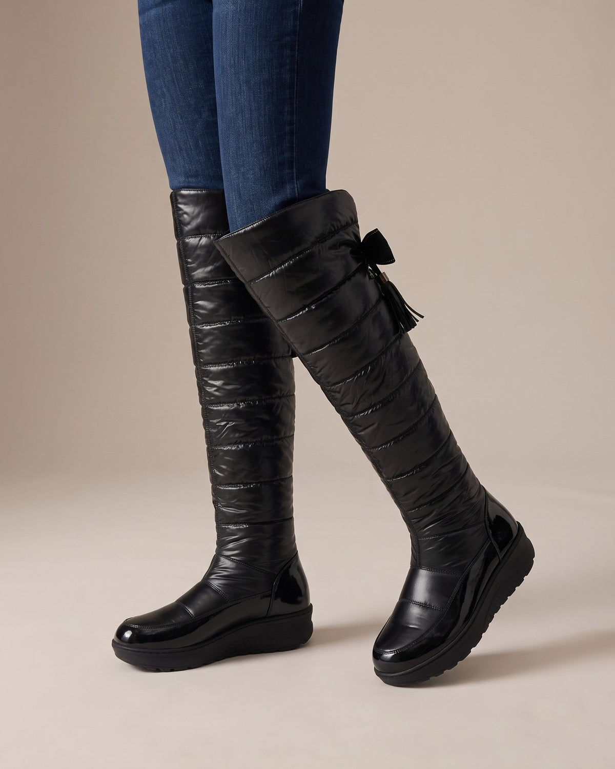 Adeline quilted tall boots worn with jeans, studio shot of legs