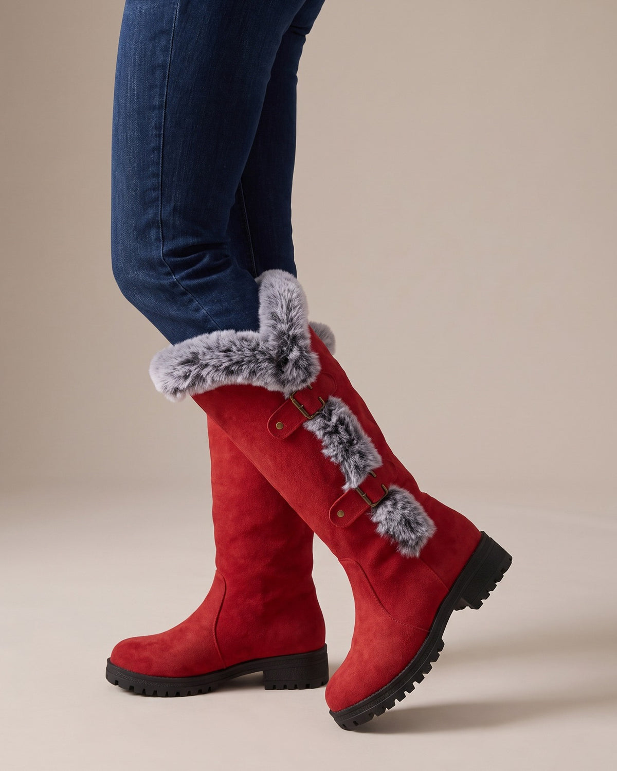 Beatrix red tall boots worn with jeans, studio shot of legs
