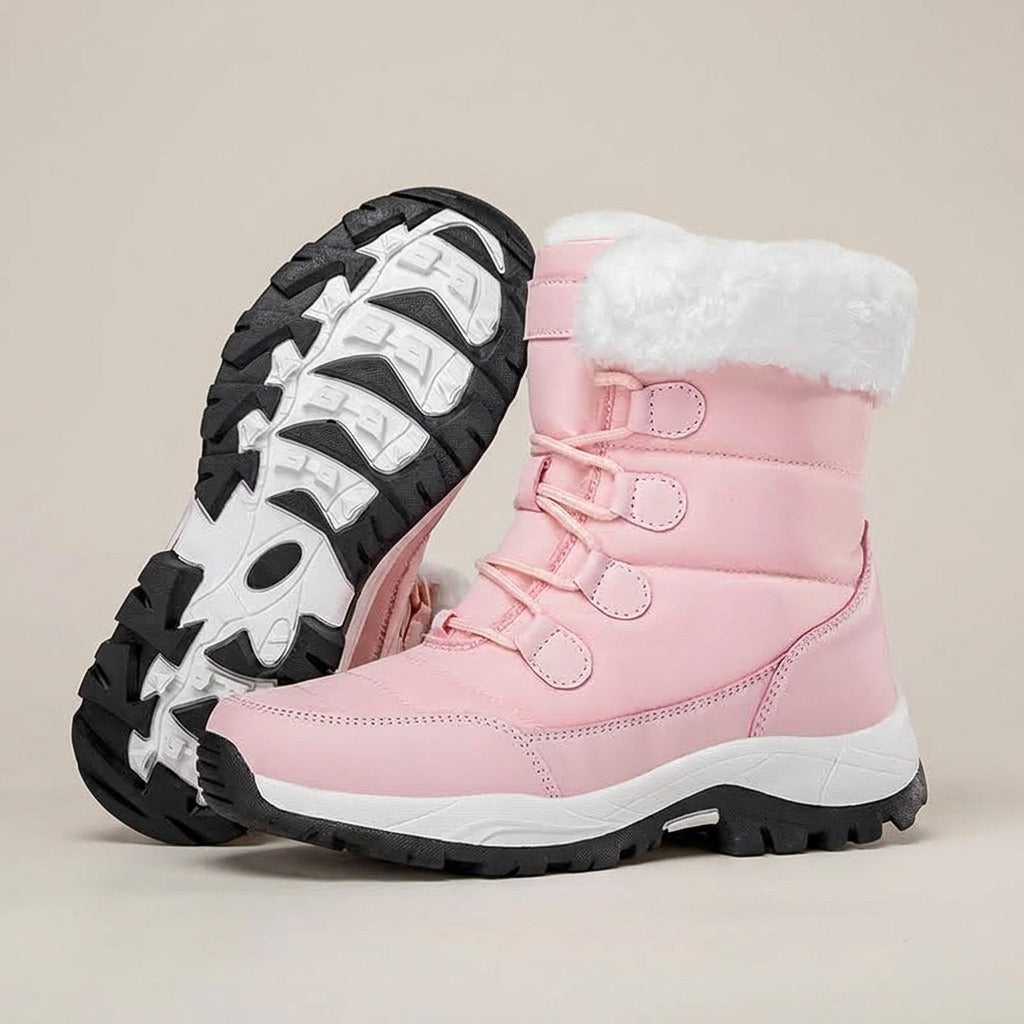 Birdie pink lace-up snow boots with white plush cuff, one turned to show the lugged sole