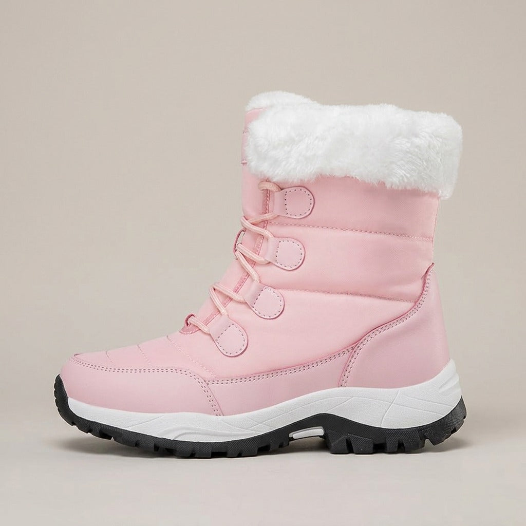 Birdie pink snow boot, side view of the quilted upper and lug sole