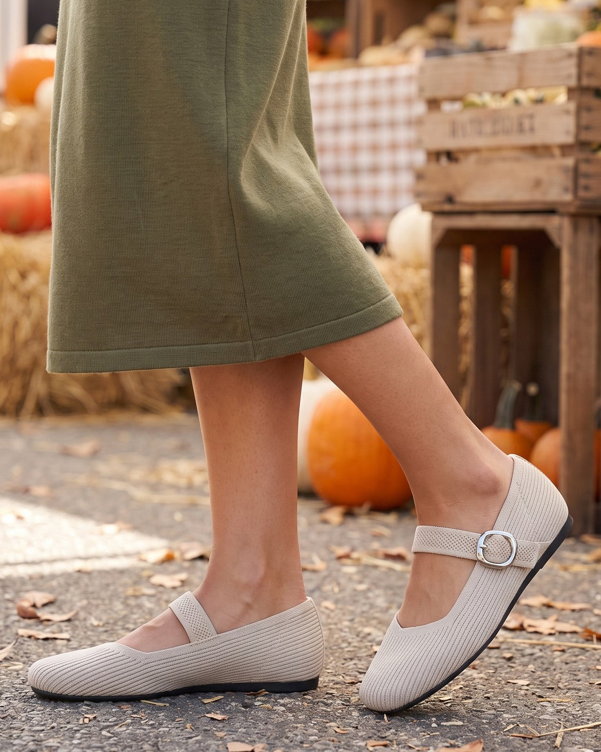 Celia knit Mary Jane flats worn with an olive skirt at an autumn market