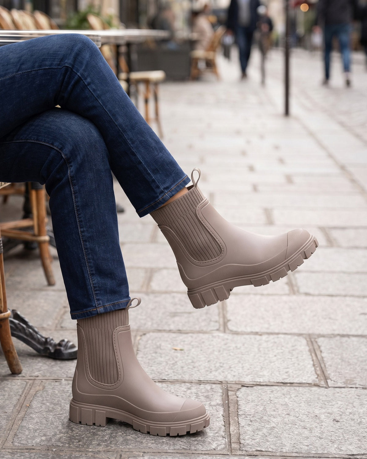 Clover taupe chelsea boots worn with jeans at a sidewalk café