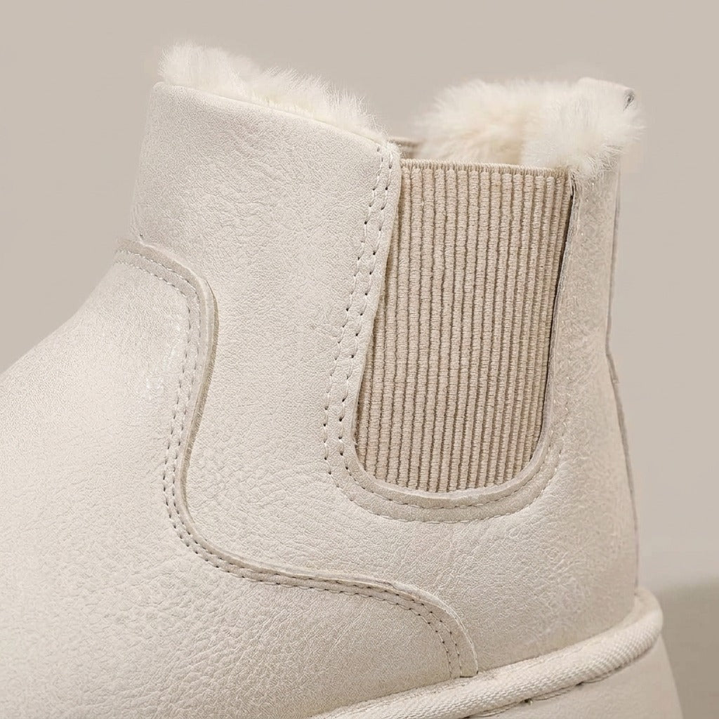 Close-up of the elastic side panel and plush collar on the Coral boot