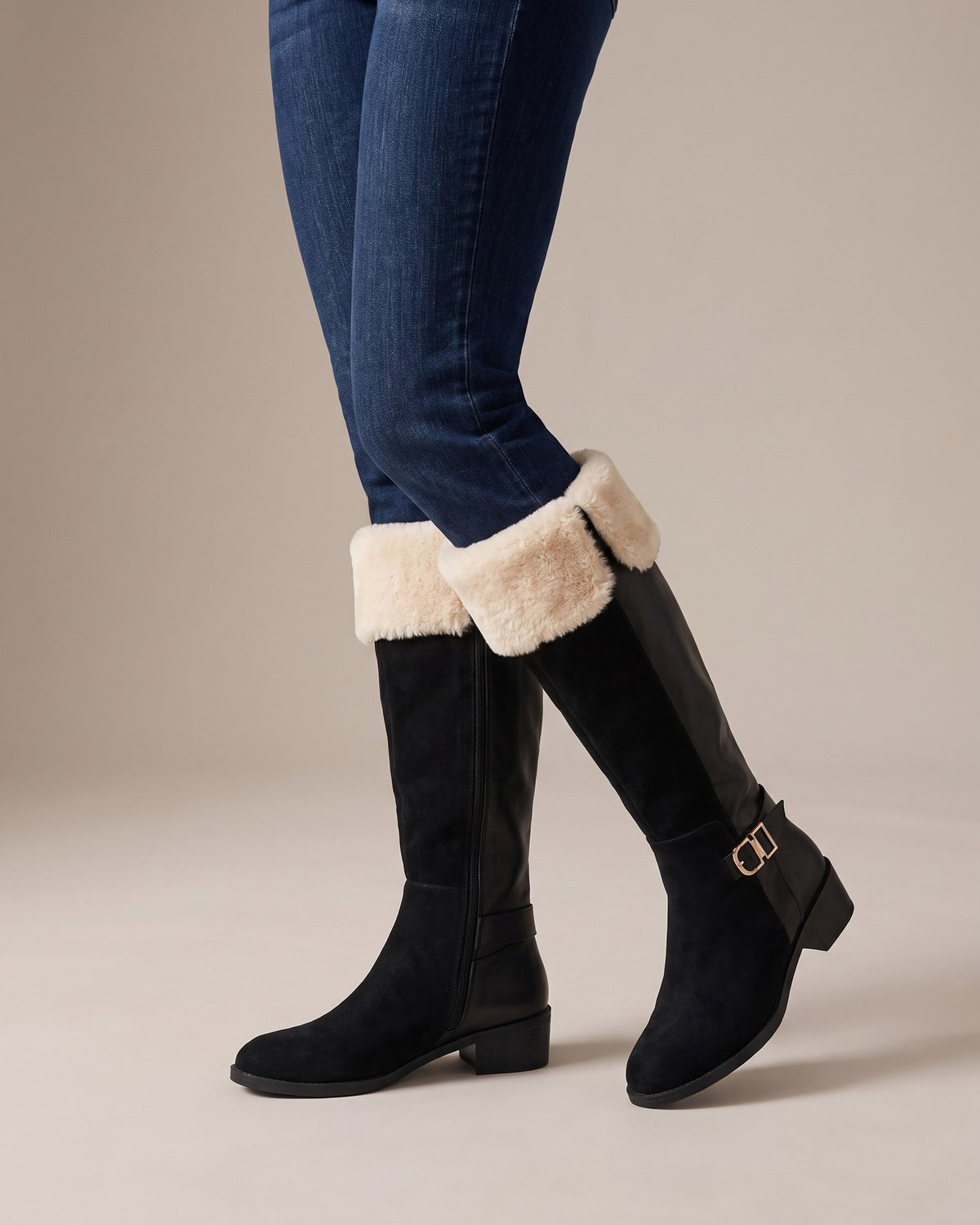 Etta black knee-high boots worn with jeans, studio shot of legs
