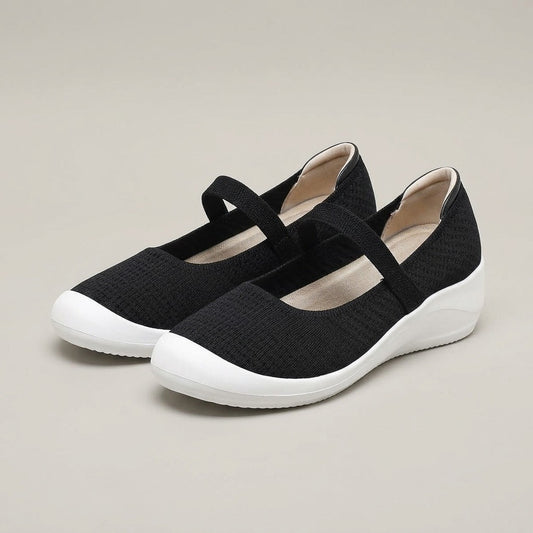 Faye black knit Mary Jane shoes with an elastic strap and white wedge sole, pair