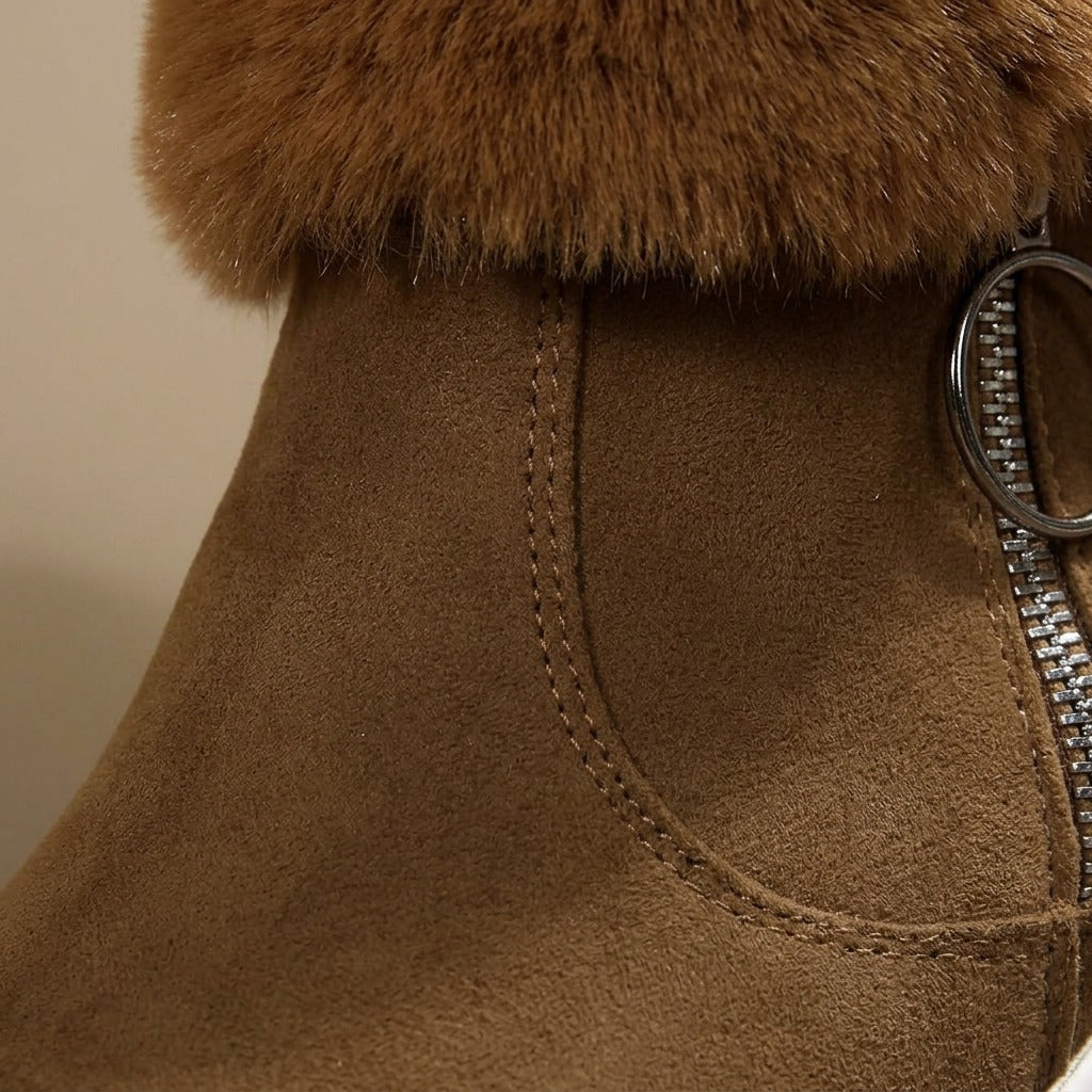 Close-up of the side zip ring pull and plush cuff on the Flora boot
