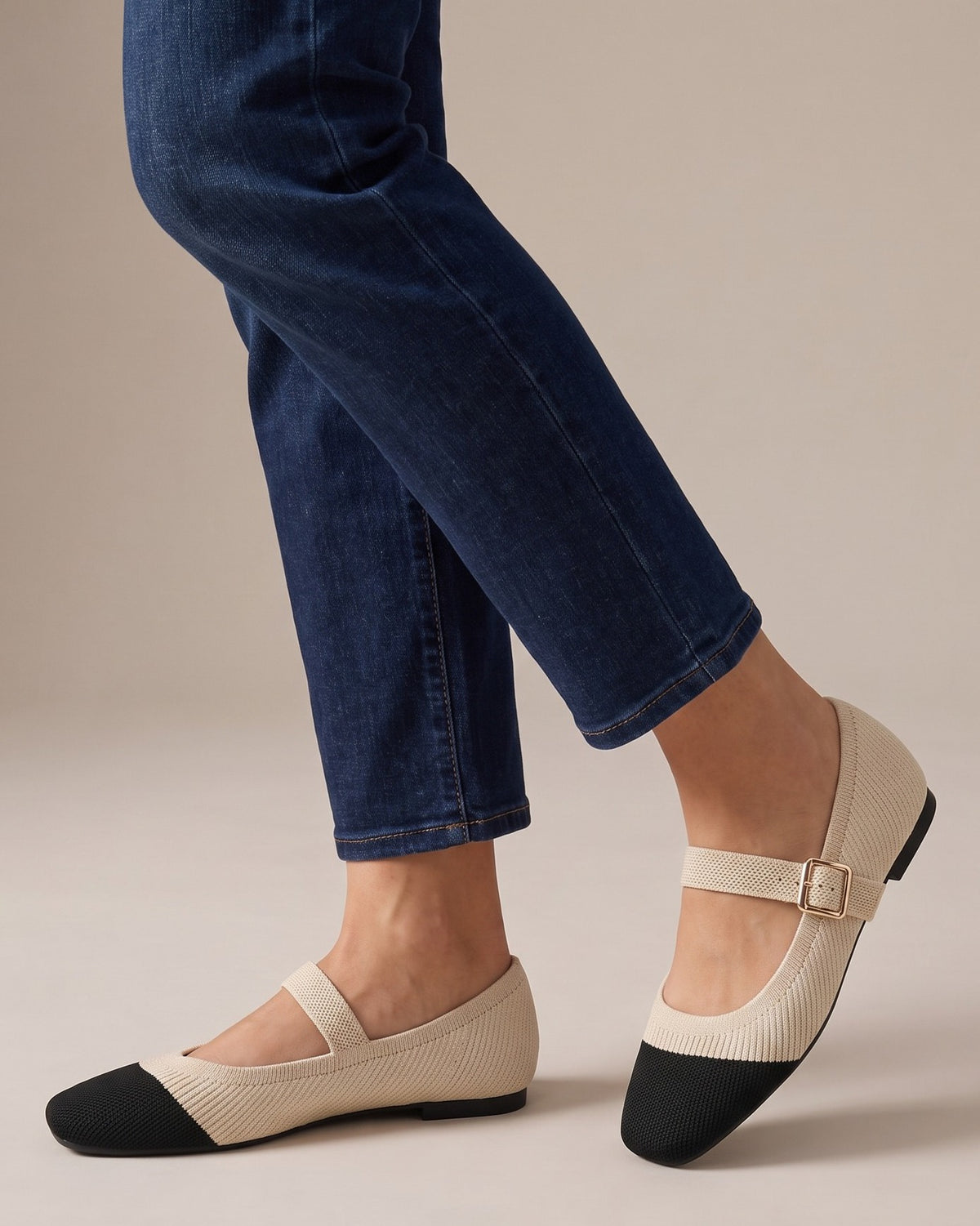 Greta cap-toe Mary Janes worn with jeans, studio shot of legs