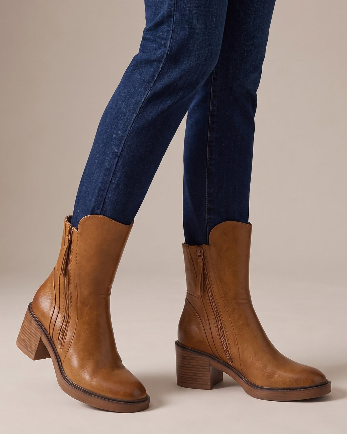 Hazel cognac ankle boots worn with jeans, studio shot of legs