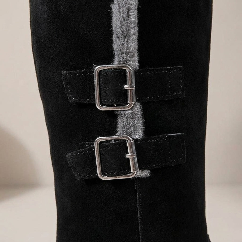 Close-up of the two silver buckles and grey plush trim on the Ida boot