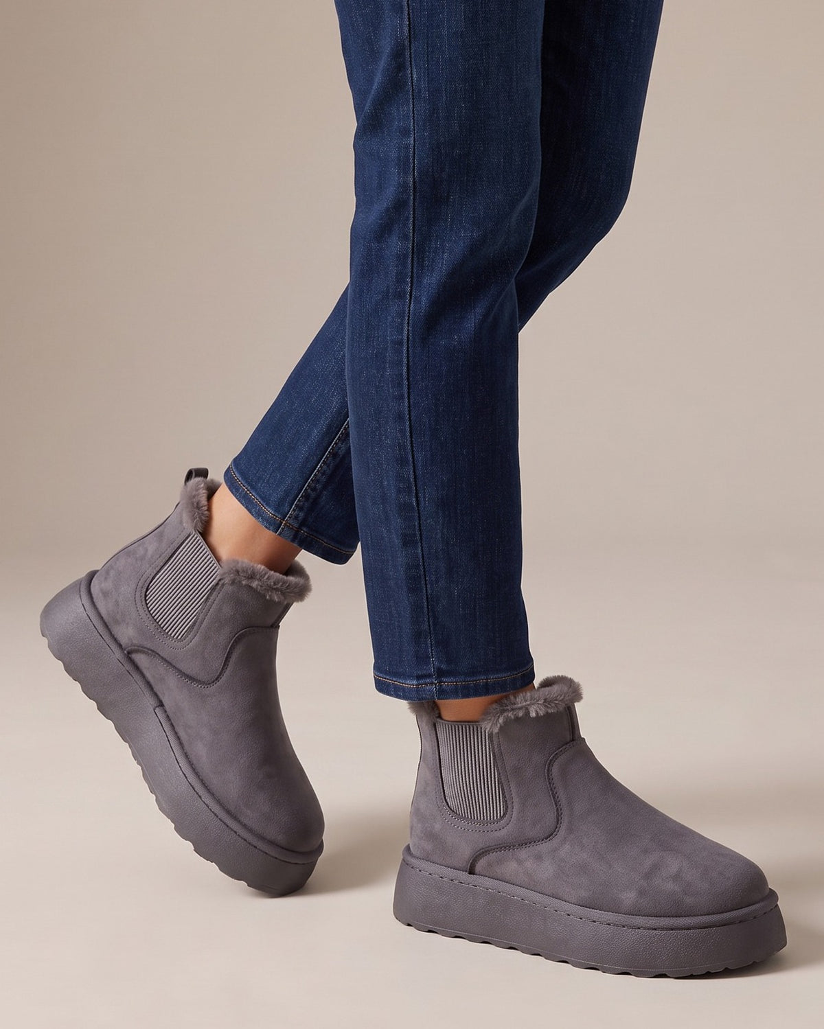 Ivy grey chelsea boots worn with jeans, studio shot of legs