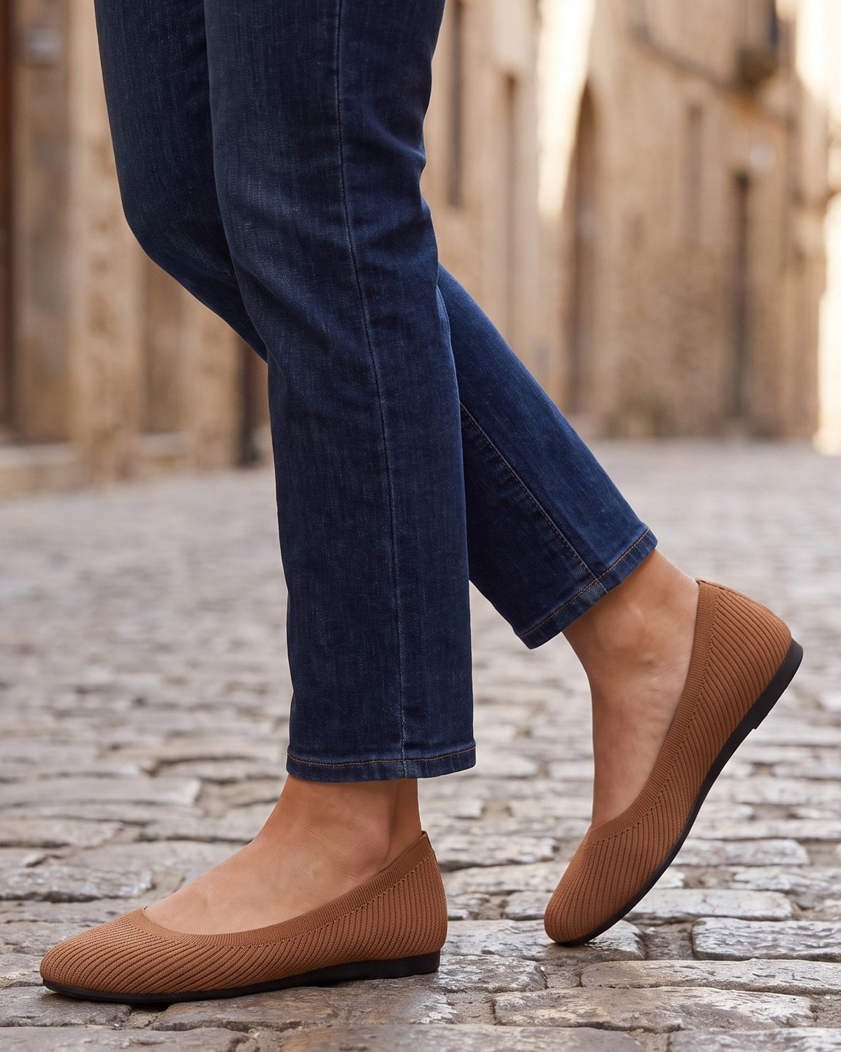 June ribbed knit flats worn with jeans on a cobblestone street