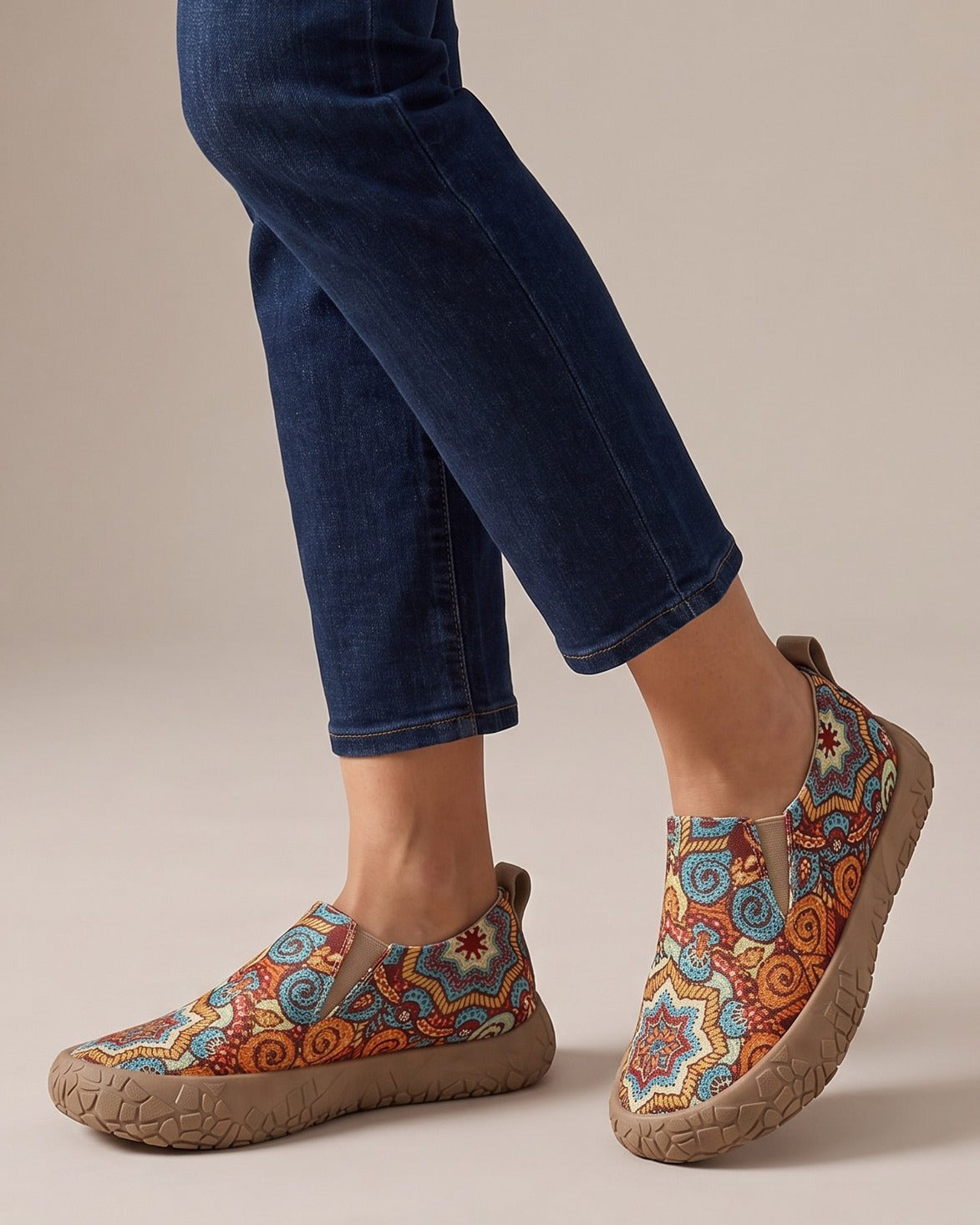 Juniper paisley slip-ons worn with jeans, studio shot of legs