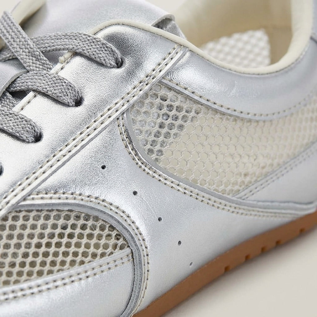 Close-up of the silver overlays, mesh panel and laces on the Juno sneaker
