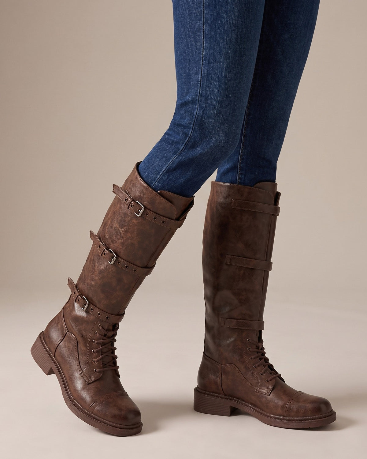 Lark brown tall boots worn with jeans, studio shot of legs