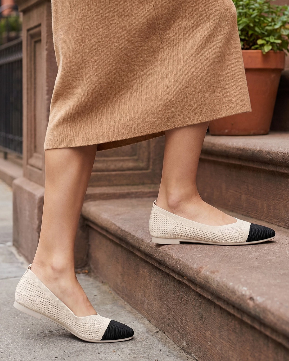 Lottie two-tone pointed flats worn with a camel skirt on brownstone steps