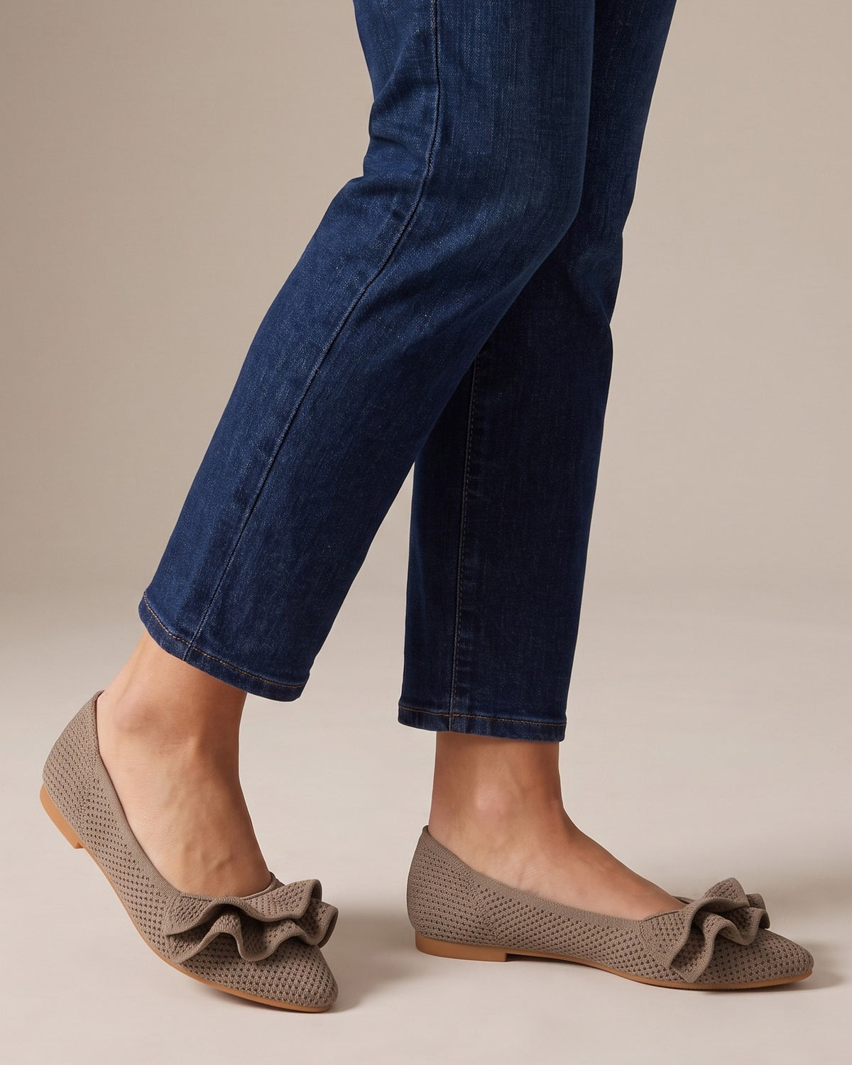 Mabel ruffle knit flats worn with jeans, studio shot of legs