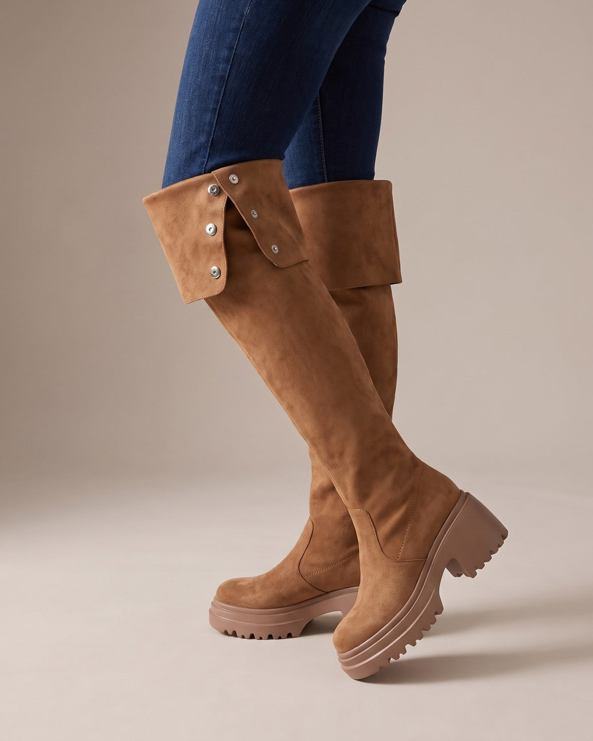 Mira tan tall boots worn with jeans, studio shot of legs