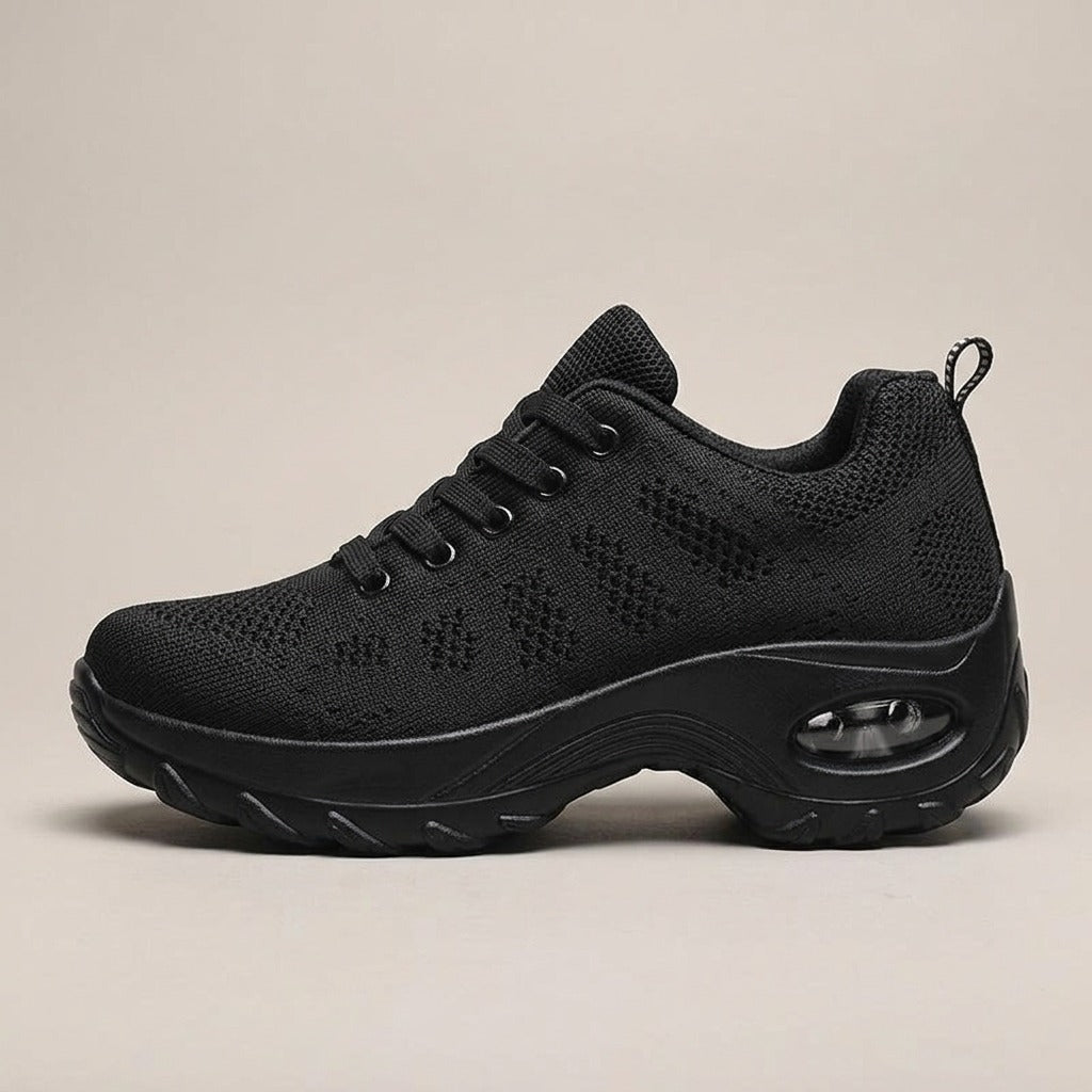 Nell black sneaker, side view of the rocker sole