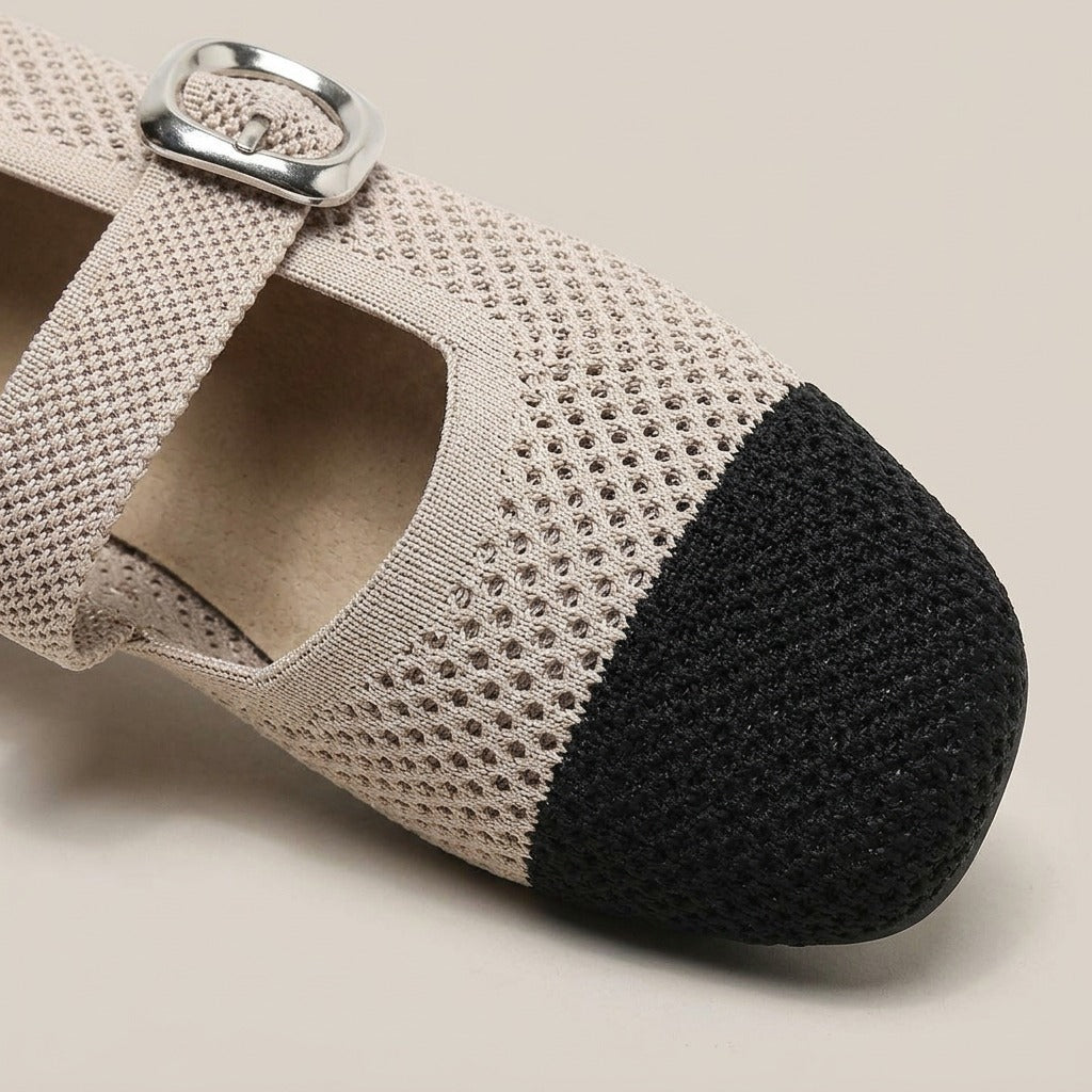 Close-up of the black cap toe, perforated knit and buckle on the Nina flat