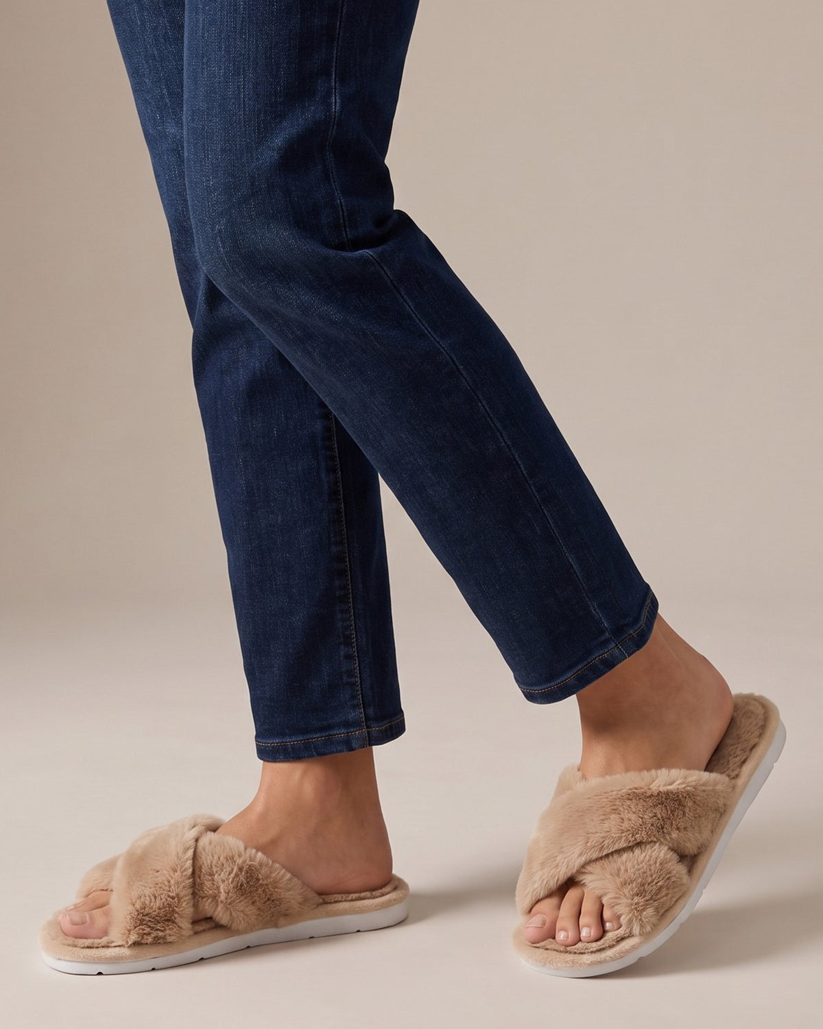 Nova plush slides worn with jeans, studio shot of legs