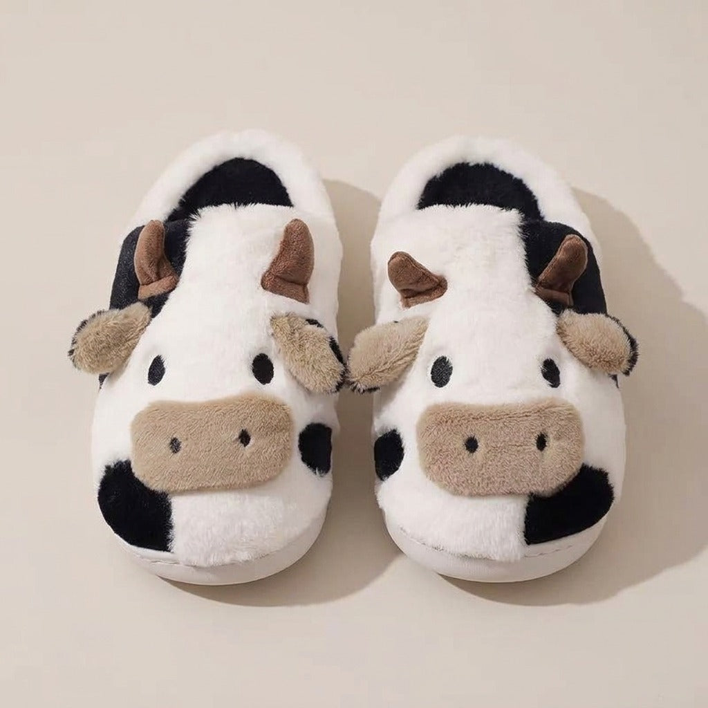 Odette cow-print slippers, pair, front view of the cow faces