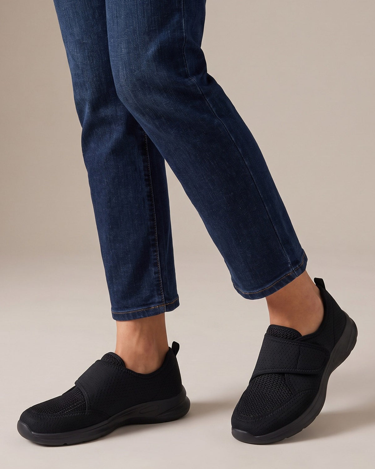 Opal black strap shoes worn with jeans, studio shot of legs