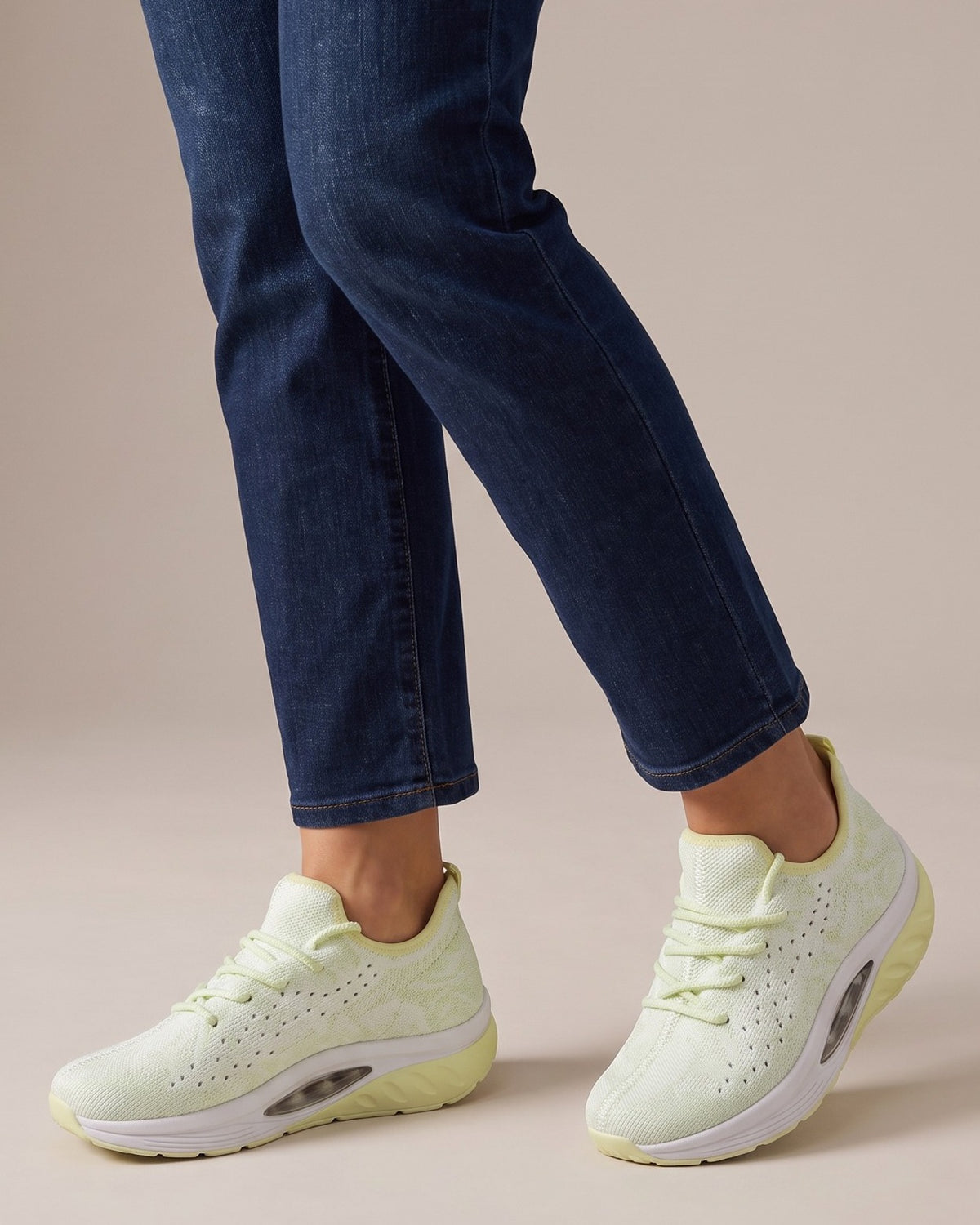 Pippa knit trainers worn with jeans, studio shot of legs