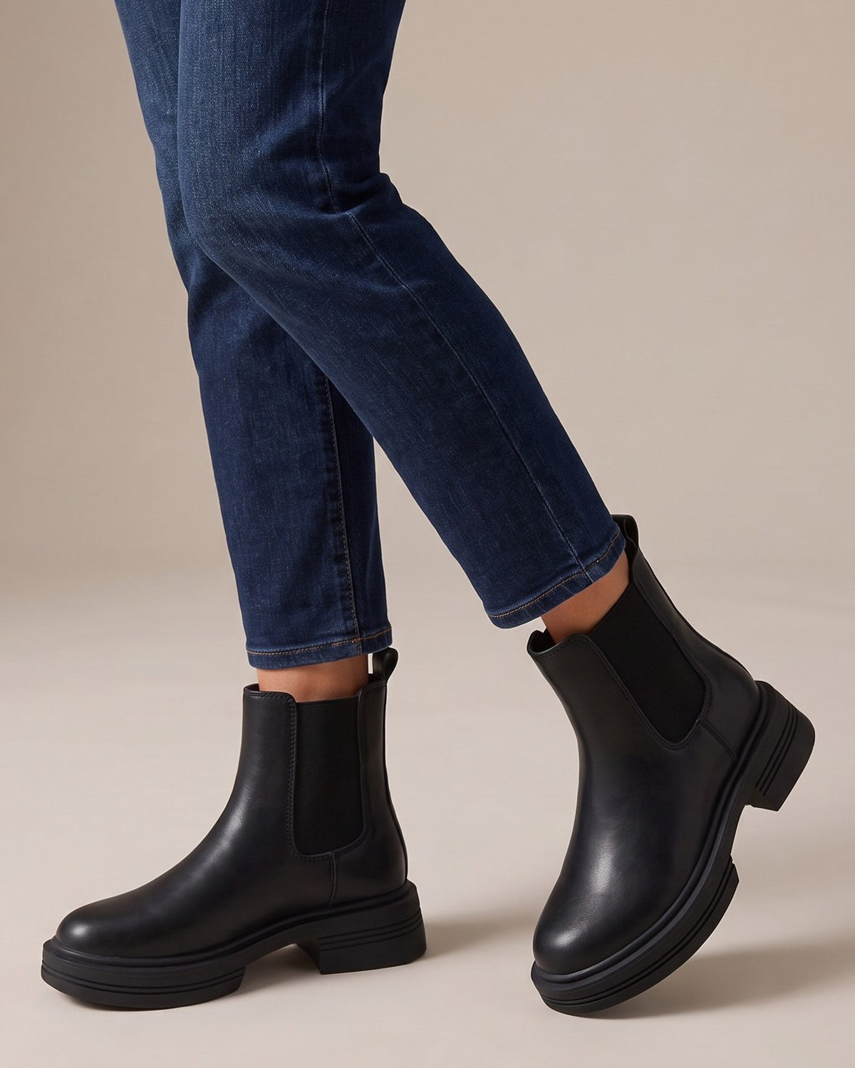 Quinn black chelsea boots worn with jeans, studio shot of legs