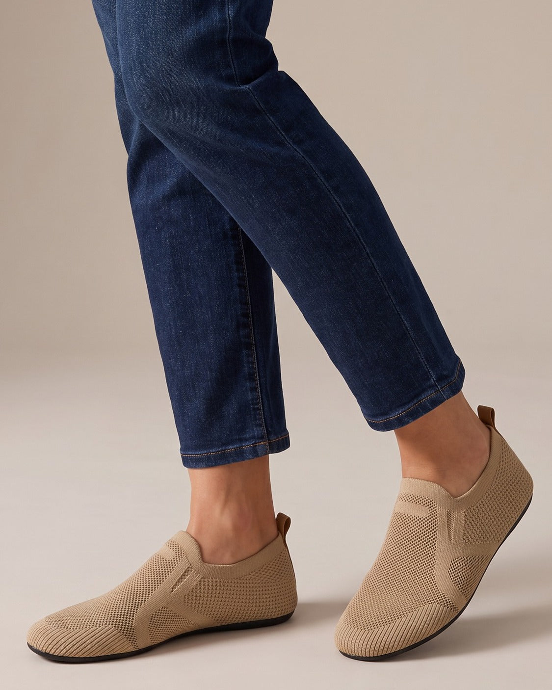 Reese tan knit loafers worn with jeans, studio shot of legs