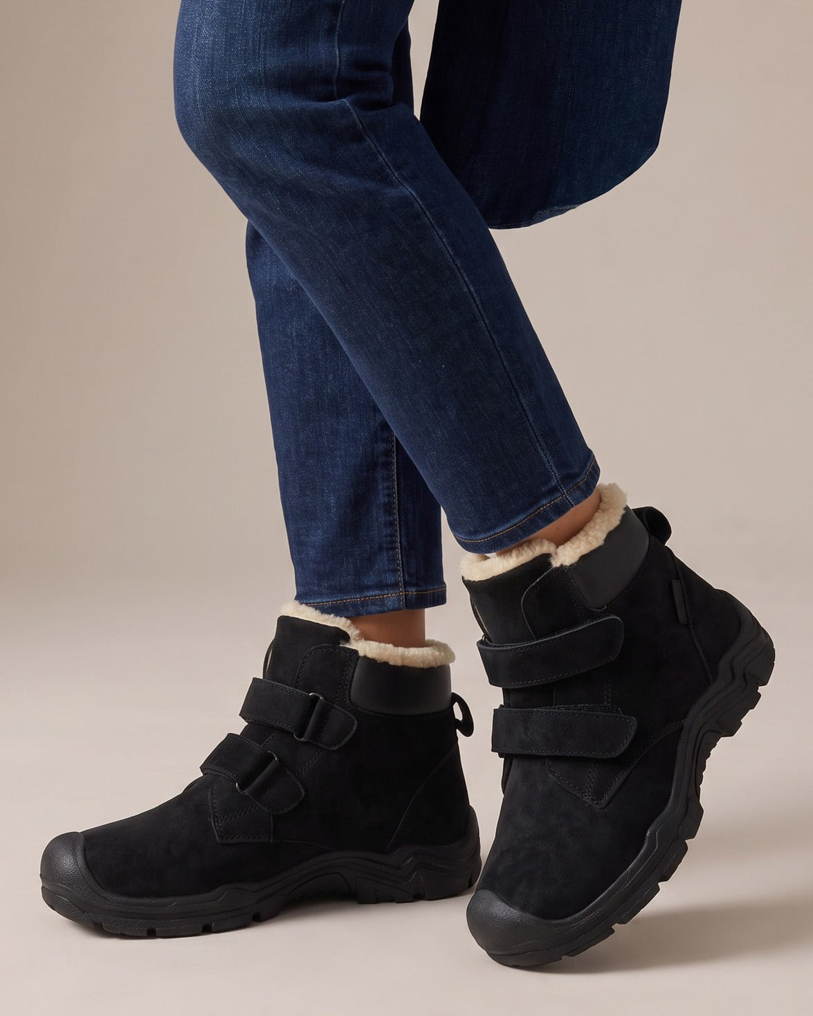 Rosa black ankle boots worn with jeans, studio shot of legs