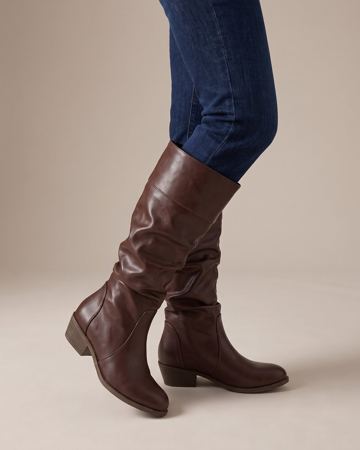 Stella brown riding boots worn with jeans, studio shot of legs