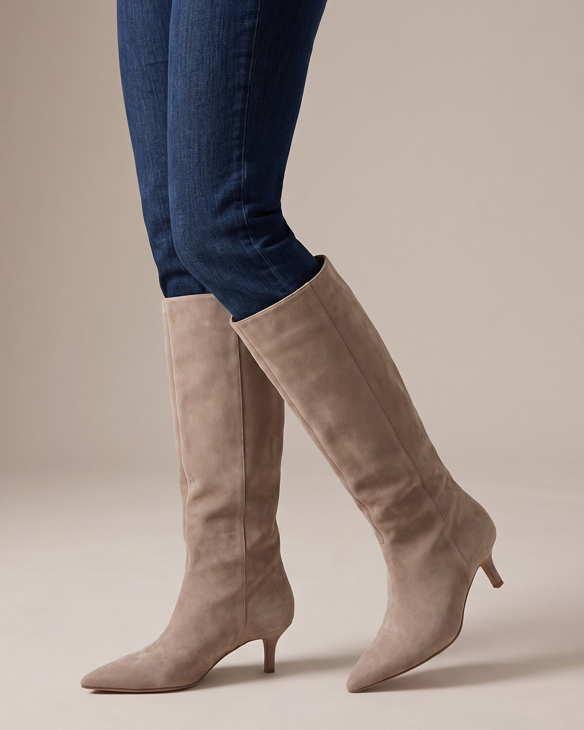 Sybil beige knee-high boots worn with jeans, studio shot of legs